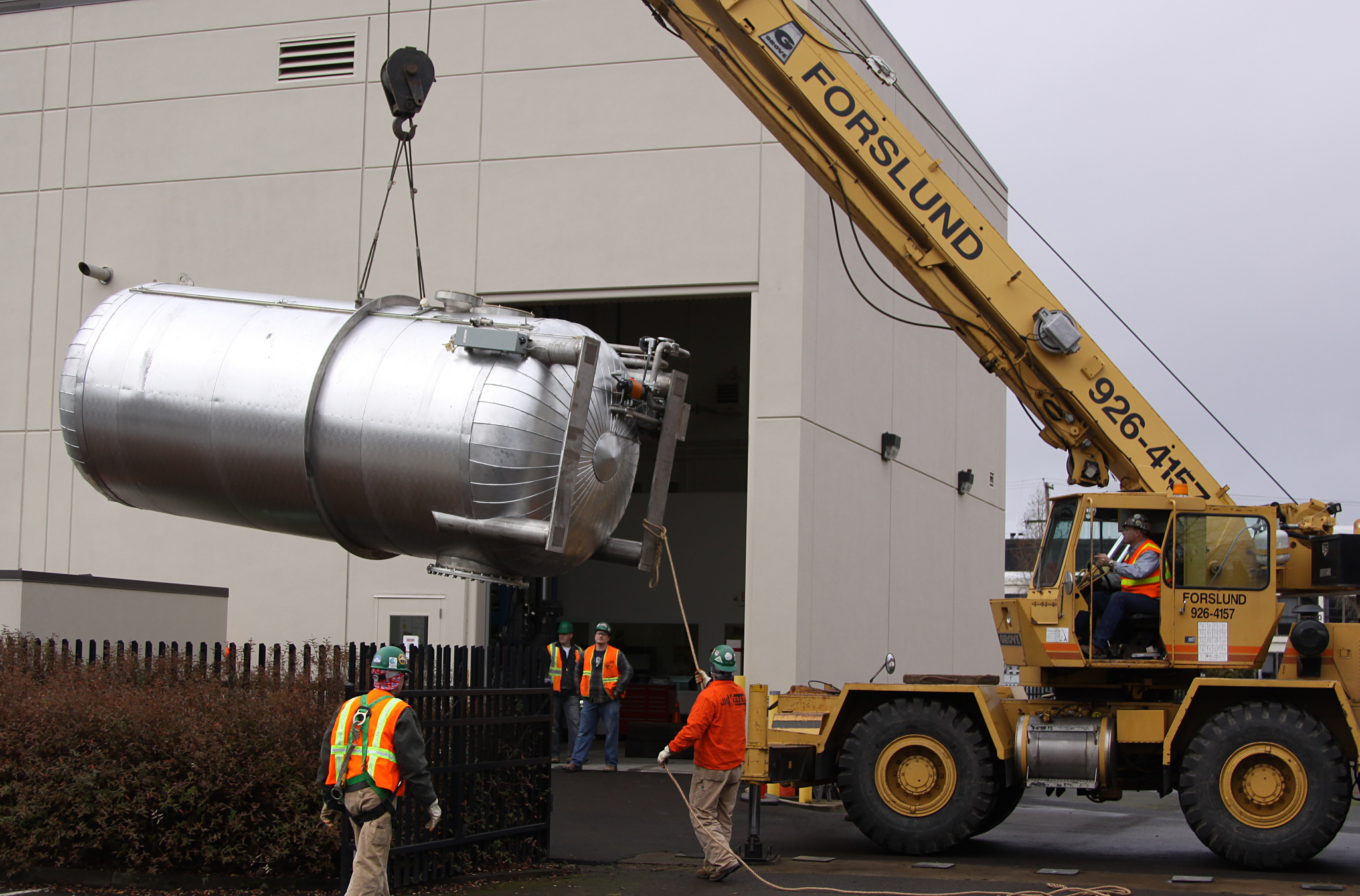 Top deck of a large fabricated tank staged at a waterfront site